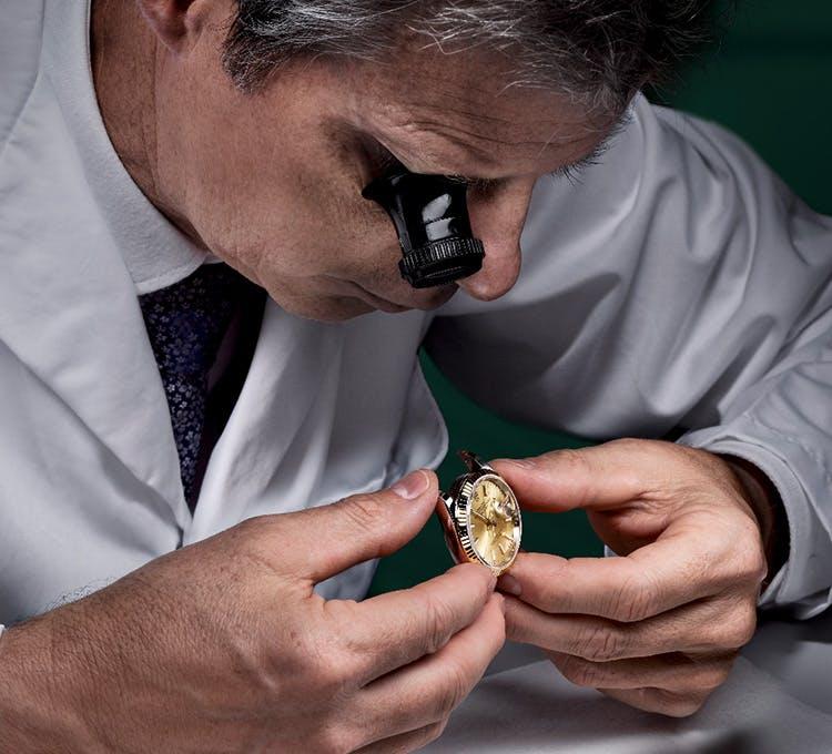 inspecting a Rolex watch at Lee Michaels Fine Jewelry stores