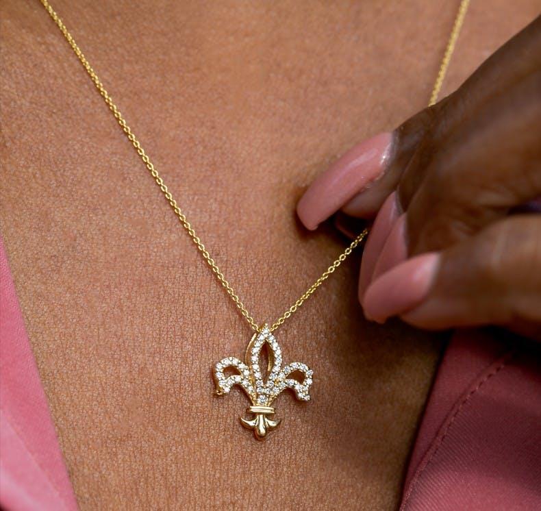 Yellow Gold and diamond Fleur de Lis necklace, by Roberto Coin. Available at Lee Michaels Fine Jewelry.