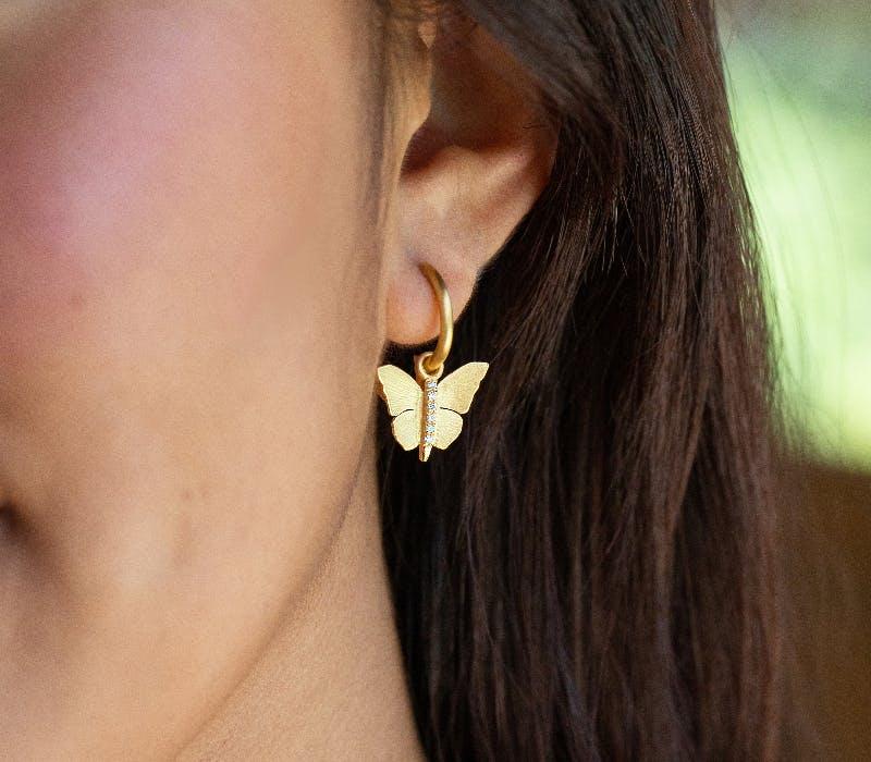 gold butterfly dangle drop earrings, available at Lee Michaels Fine Jewelry stores