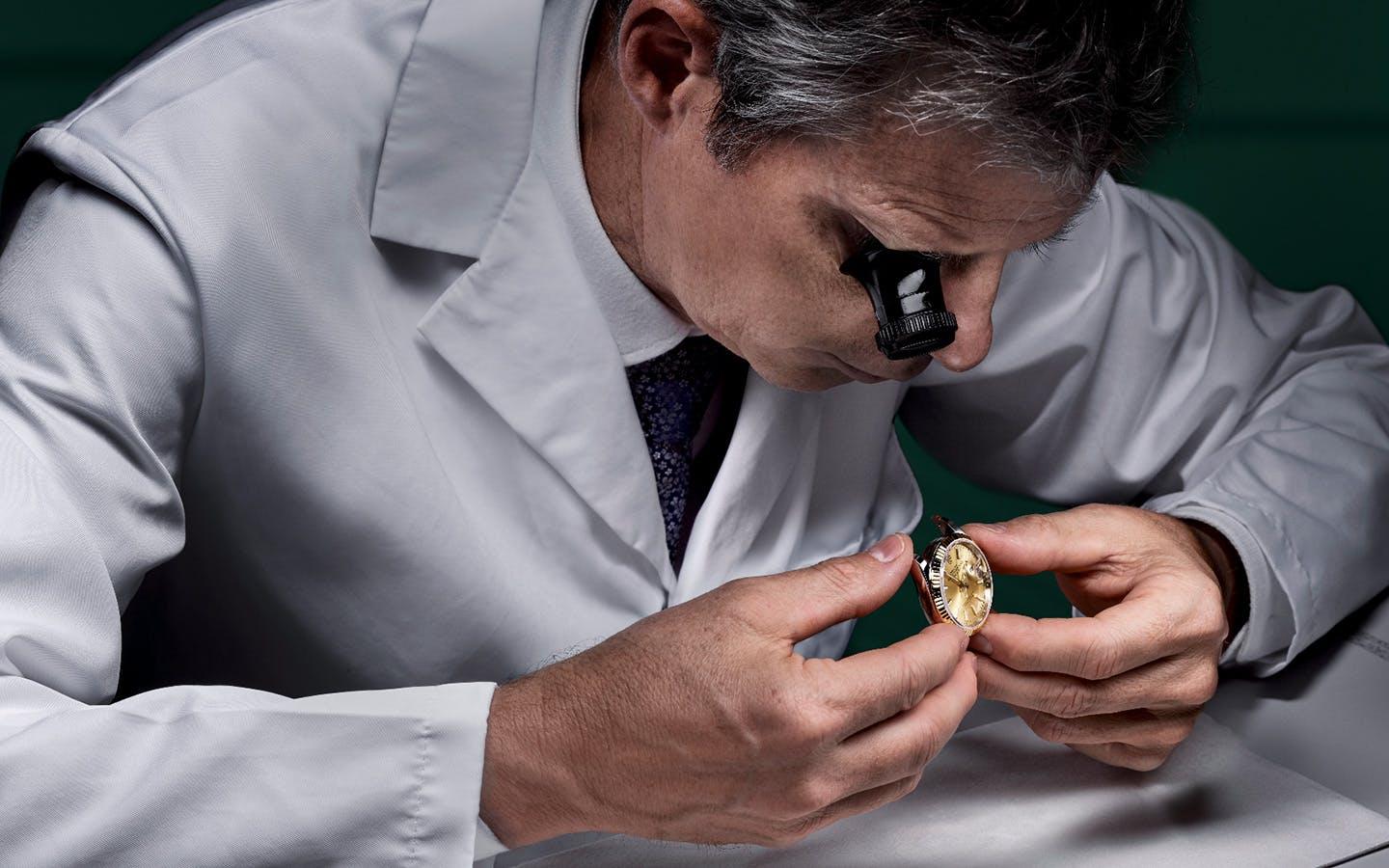 inspecting a Rolex watch at Lee Michaels Fine Jewelry stores